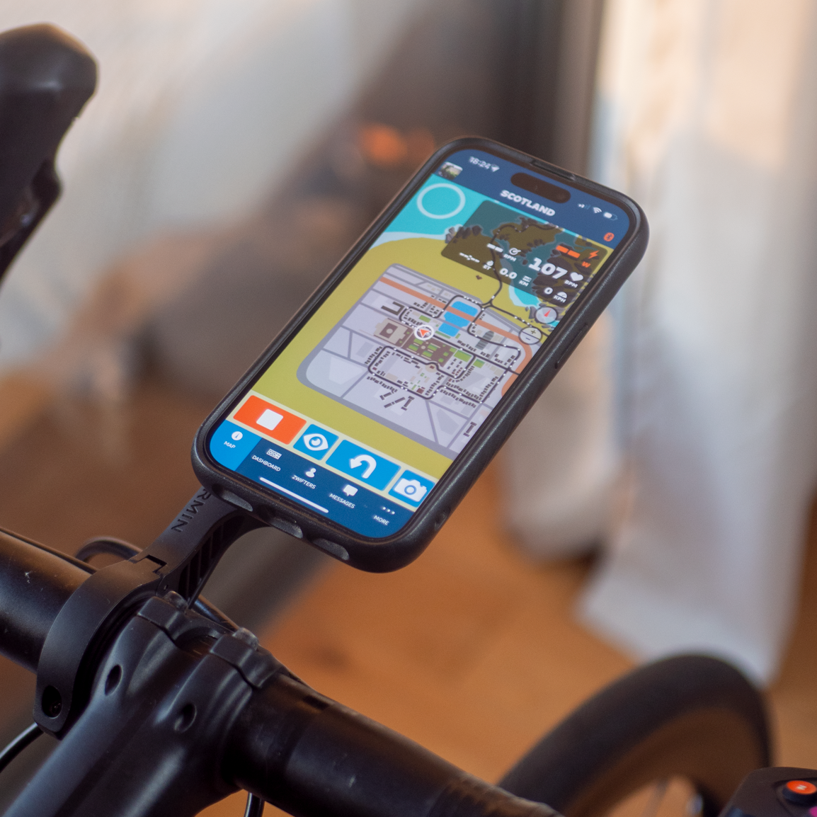 Smartphone mounted on a bicycle handlebar with a cycling app displayed.