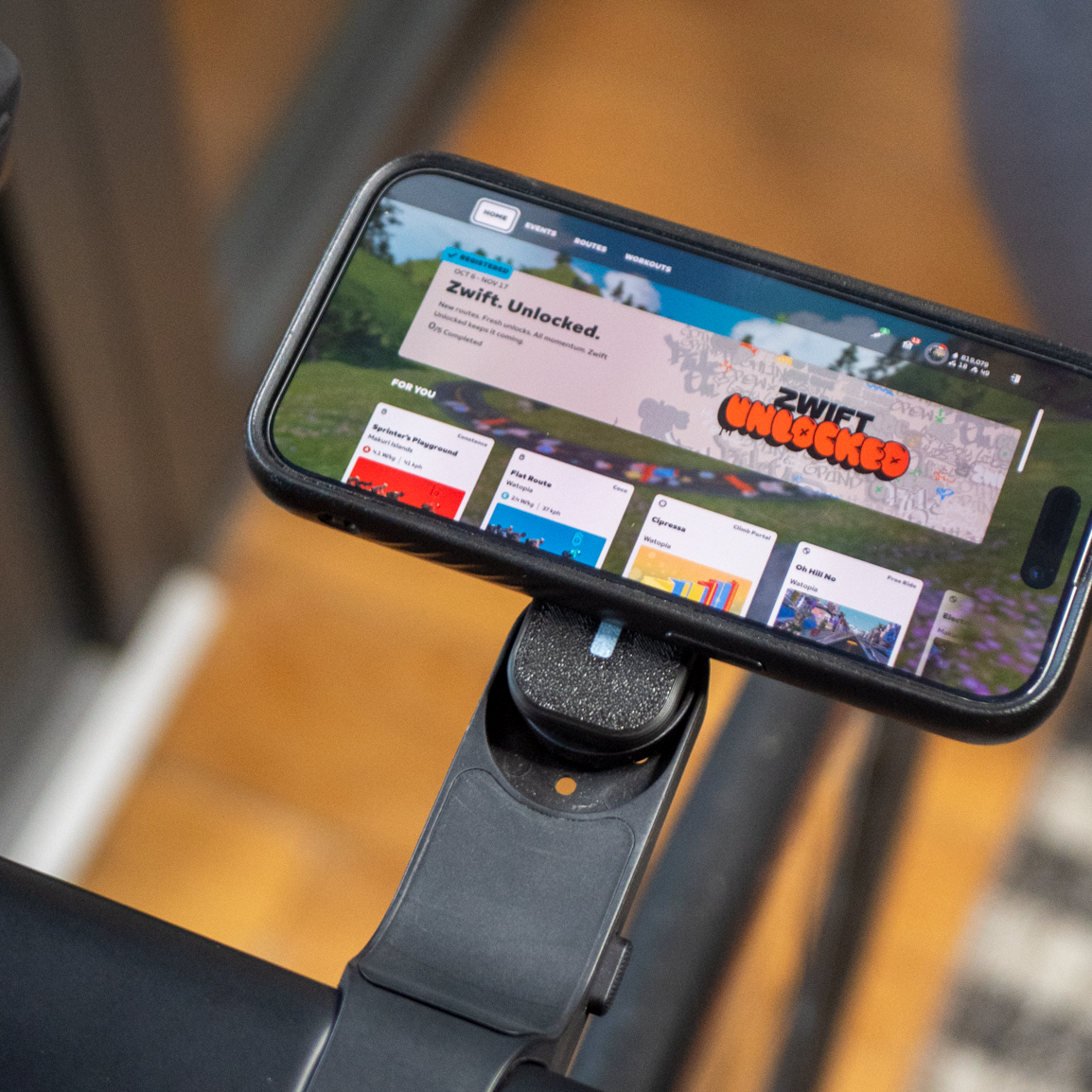 Smartphone mounted on a bike handlebar displaying a fitness app interface.