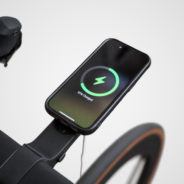 Phone charging on a Draaft MagSafe charger holder on an indoor trainer bike