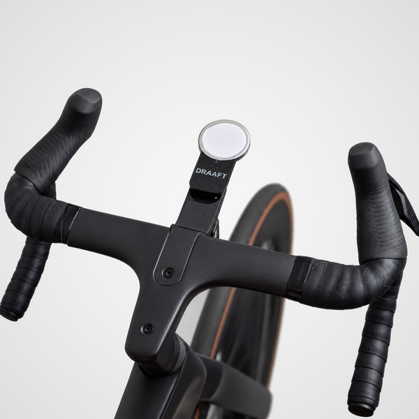 MagSafe charger holder mounted on a bike handlebar on an indoor trainer